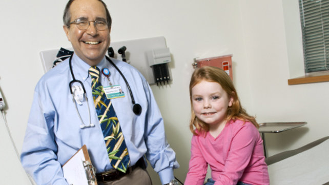 doctor  with child patient in pink shirt