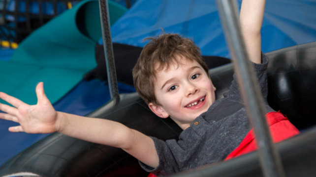 boy on indoor tire swing