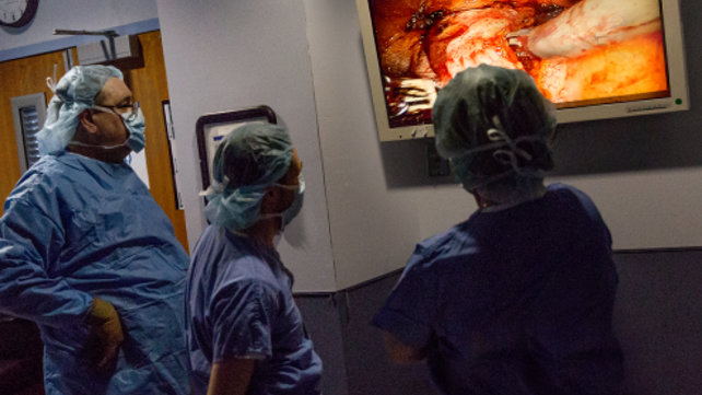 Surgeons looking at a screen