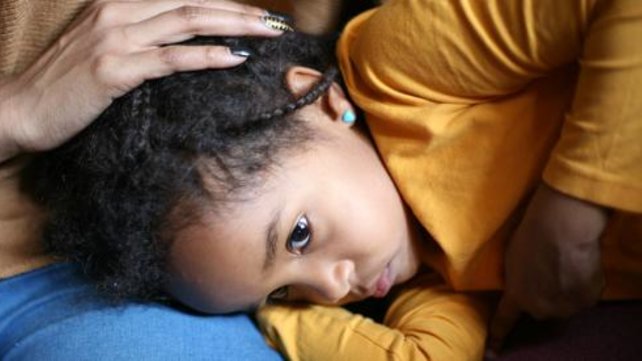 Child being comforted by an adult