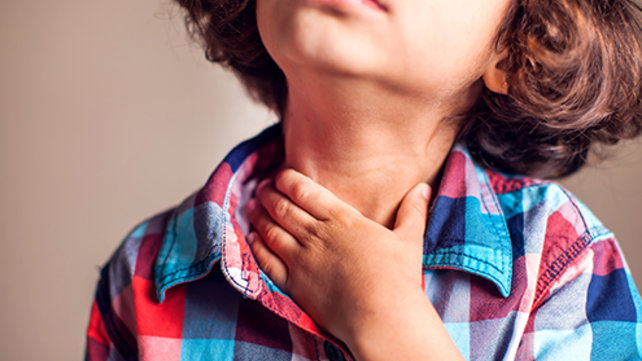 Child rubbing their throat