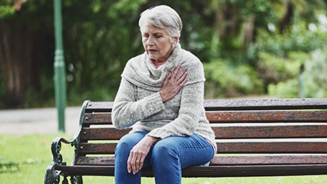 Woman exhibiting signs of a heart attack