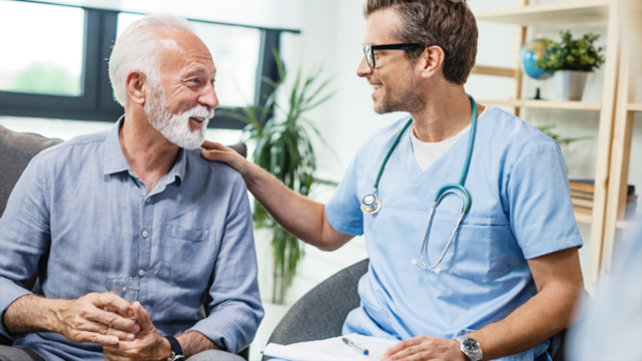 Older man speaking with a doctor.