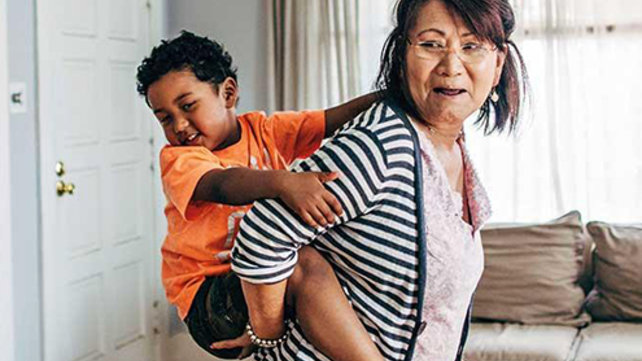 Woman carrying child on her back