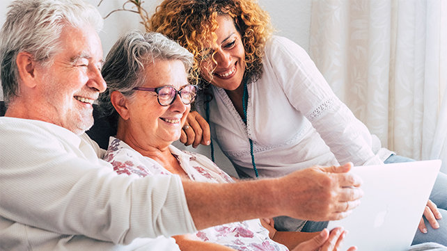 A family looks at a laptop.