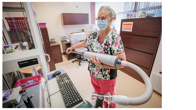 A technician calibrates a machine.
