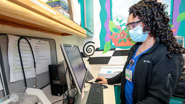 A medical tech takes initial patient readings.