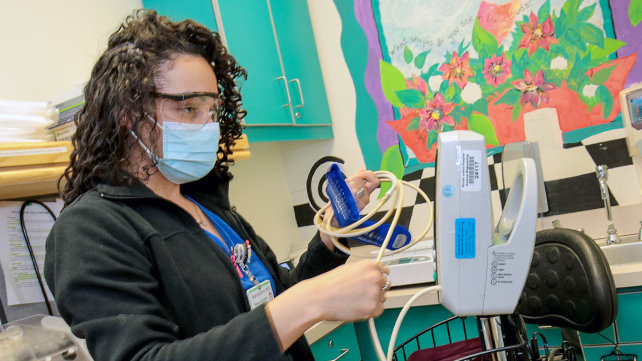 Technician gets ready to take a patient's blood pressure.