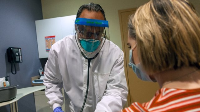 Manoj K. Garg, DO, with a patient