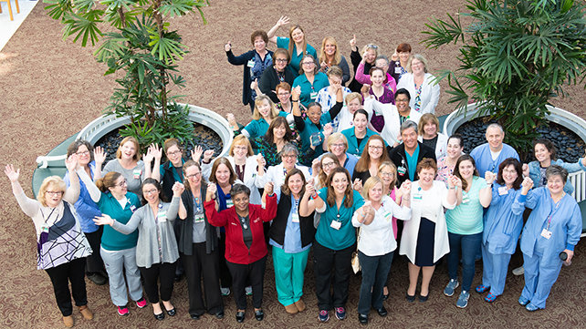 A group of Newport Hospital medical staff in the hospital atrium.