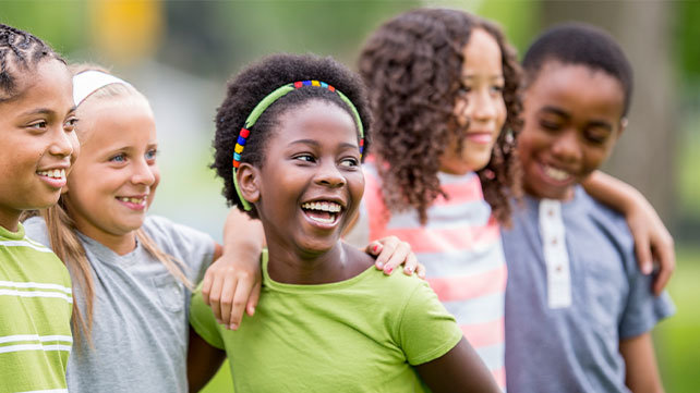 Group of children hugging and smiling 