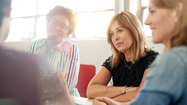 Adults talking at a table