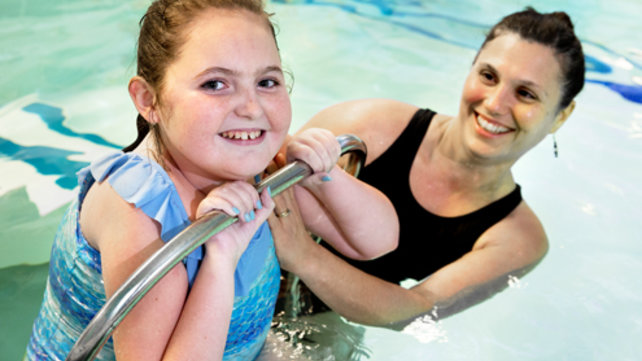 Child and adult in a pool