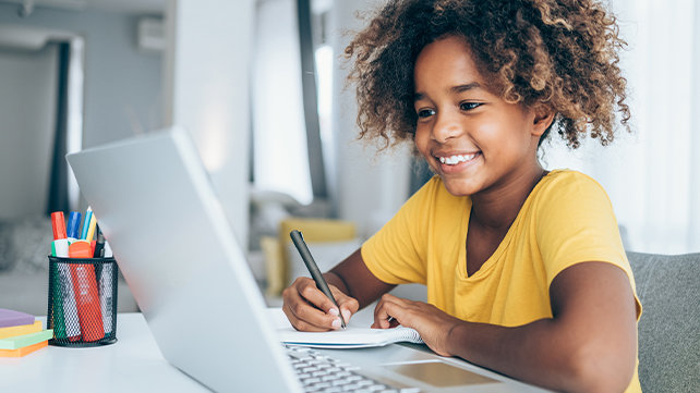 Young child working on a laptop