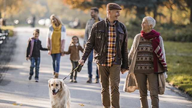 Older couple walking their dog.