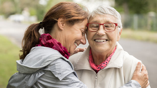 Two women smiling and hugging