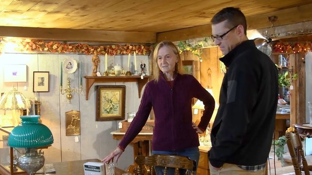 Alice Welch standing in her Antiques Shop with Dr. Alan Daniels