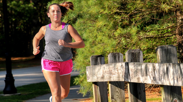 Brittney Lowe jogs along a tree-lined street.