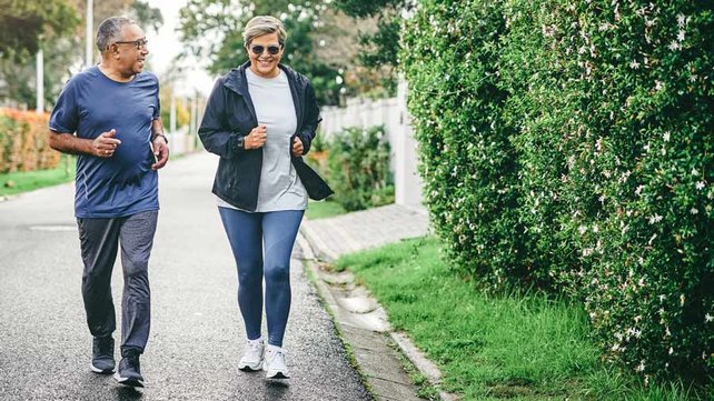 Senior couple jogging on road
