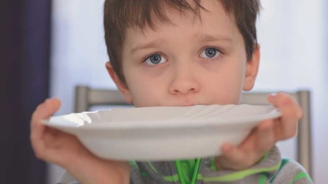 Picky eater at table with plate