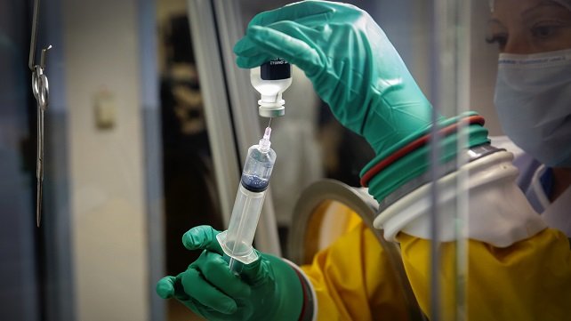 Pharmacist filling a syringe