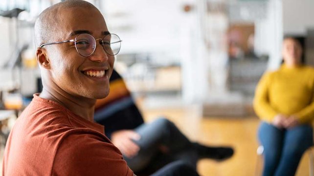 Person at group therapy session smiling