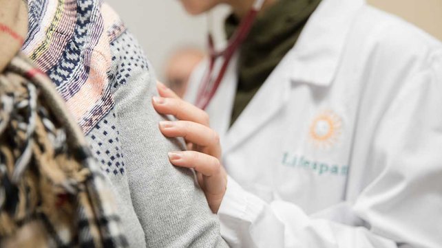 Lifespan sun on white coat with patient