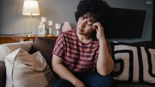 Women on couch uncomfortable