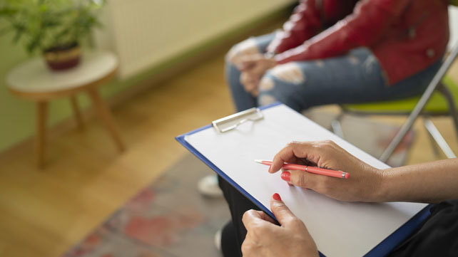 Close up image of someone taking notes on a notepad
