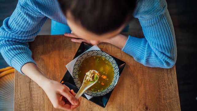 Women eating chicken soup