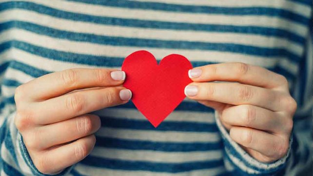 Women holding heart shaped card