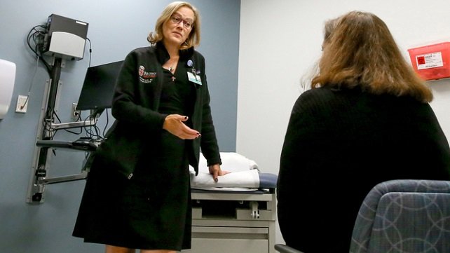 Christine M. Duffy, MD, Director, Adult Cancer Survivorship Program, Lifespan Cancer Institute, consulting with a patient.