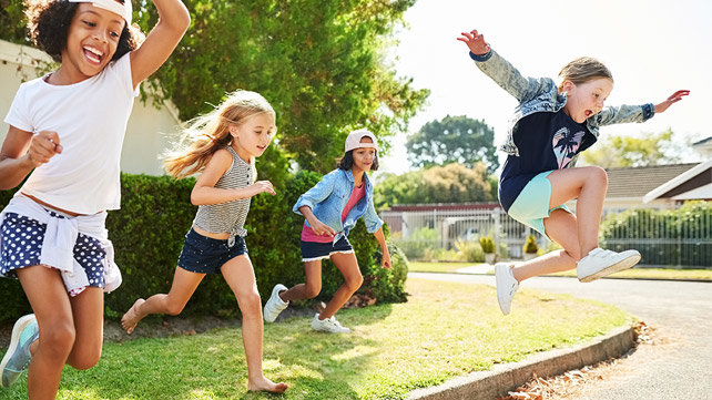 Children running and jumping outdoors.