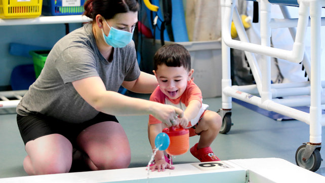 Therapist works with a young boy