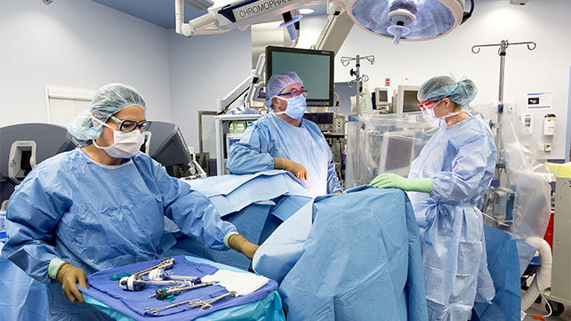 Medical clinicians in an operating room.