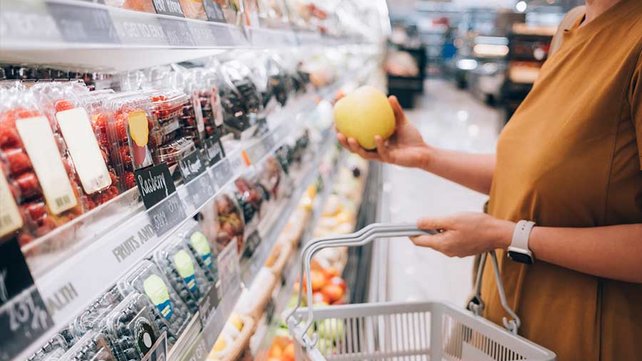 Women shopping for vegetables in grocery store