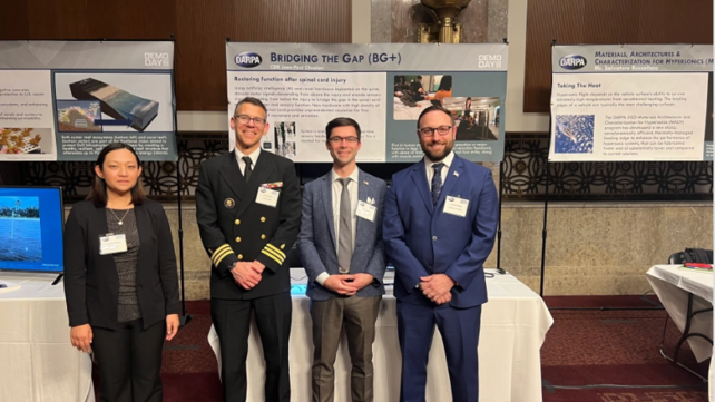 four people standing for photo