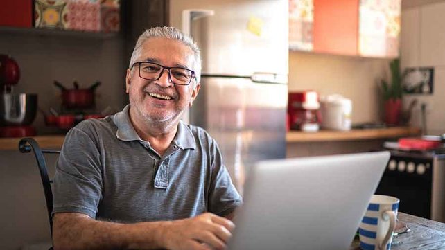 Older man researching on computer