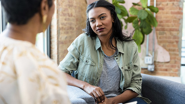 Woman sitting and talking with a counselor
