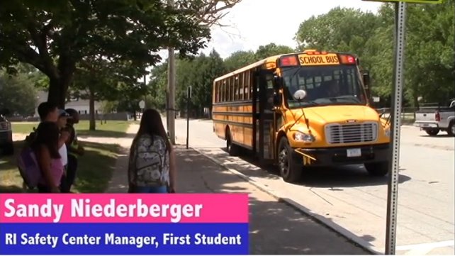Children waiting at a bus stop for their school bus