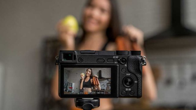 Women recording herself holding vegetables