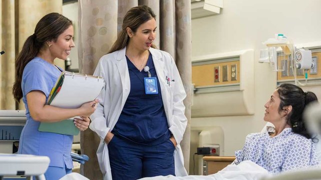 Hospitalists talking to patient