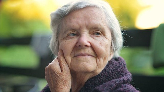 Senior woman looking into the distance with a slightly confused expression