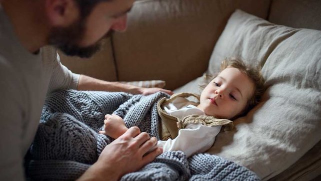 Child with RSV on couch