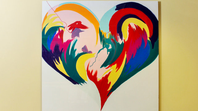 A stylized painting of a heart, hanging on a wall.