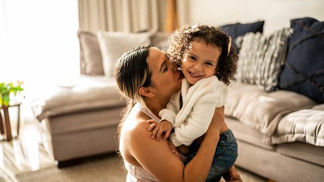 Women and toddler in living room