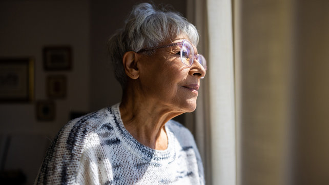 woman looking out window