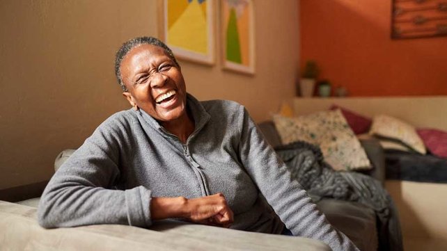 Women laughing on couch