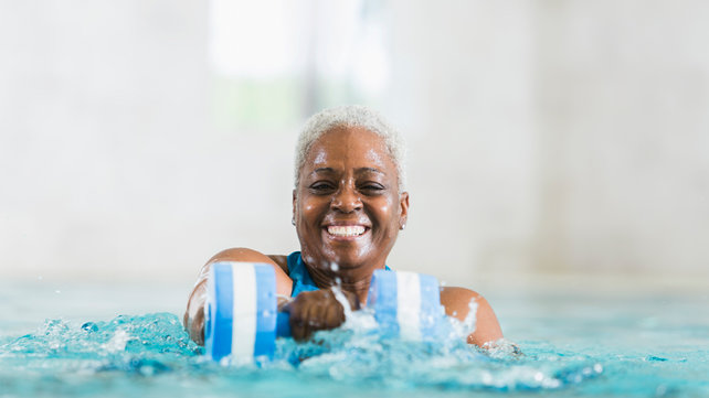 woman exercising in pool