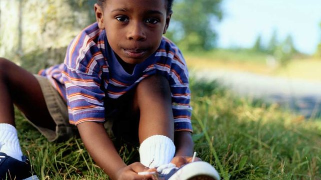 Boy tying shoes